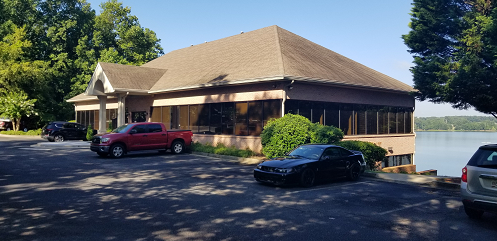 a car parked in a parking lot in front of a house