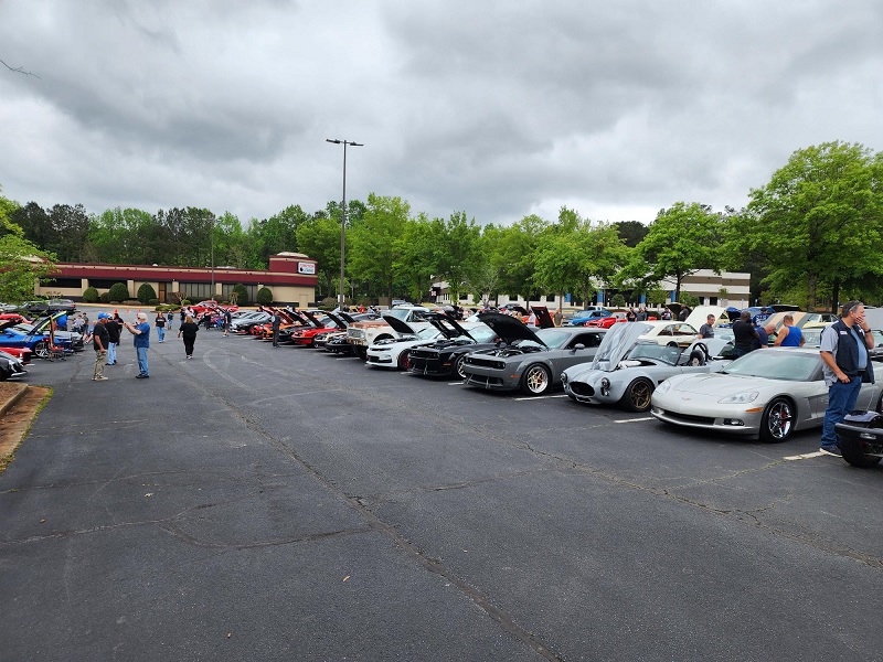 a group of people standing in a parking lot