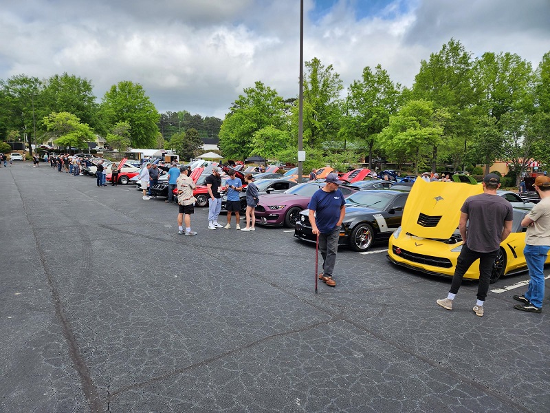 a group of people standing in a parking lot