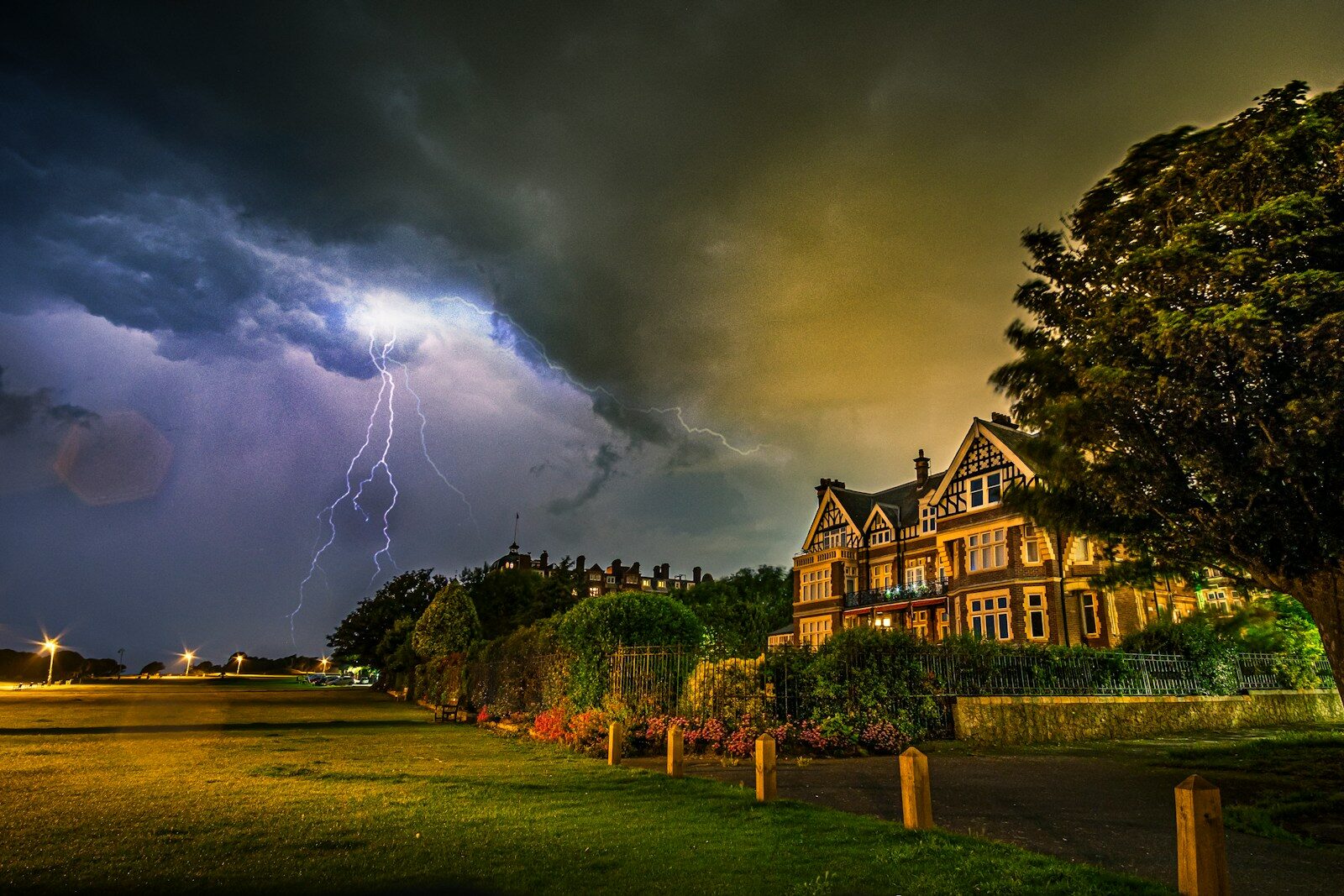 Lightning strikes near large house at night